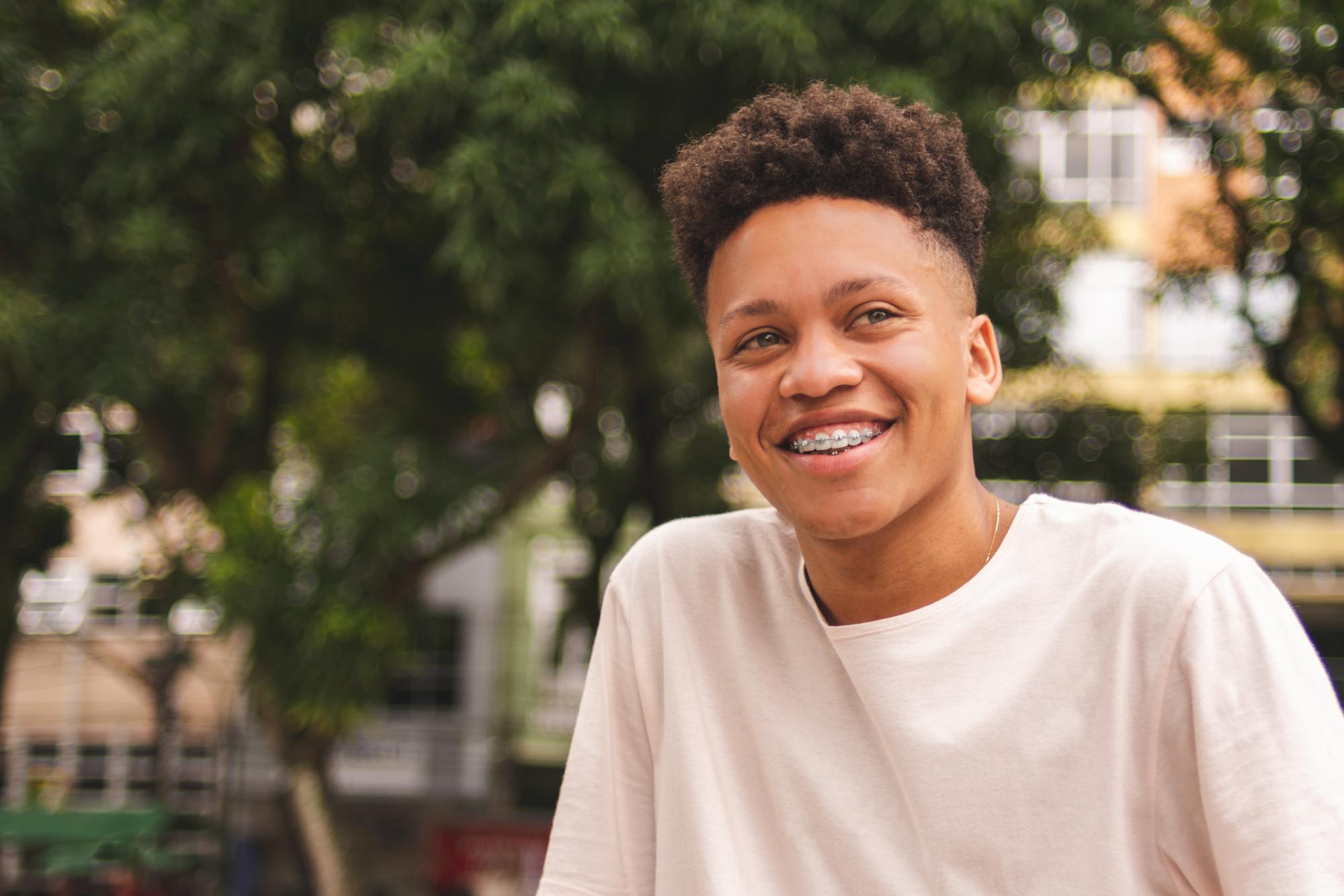 Smiling teenager with metal braces at Premier Orthodontics