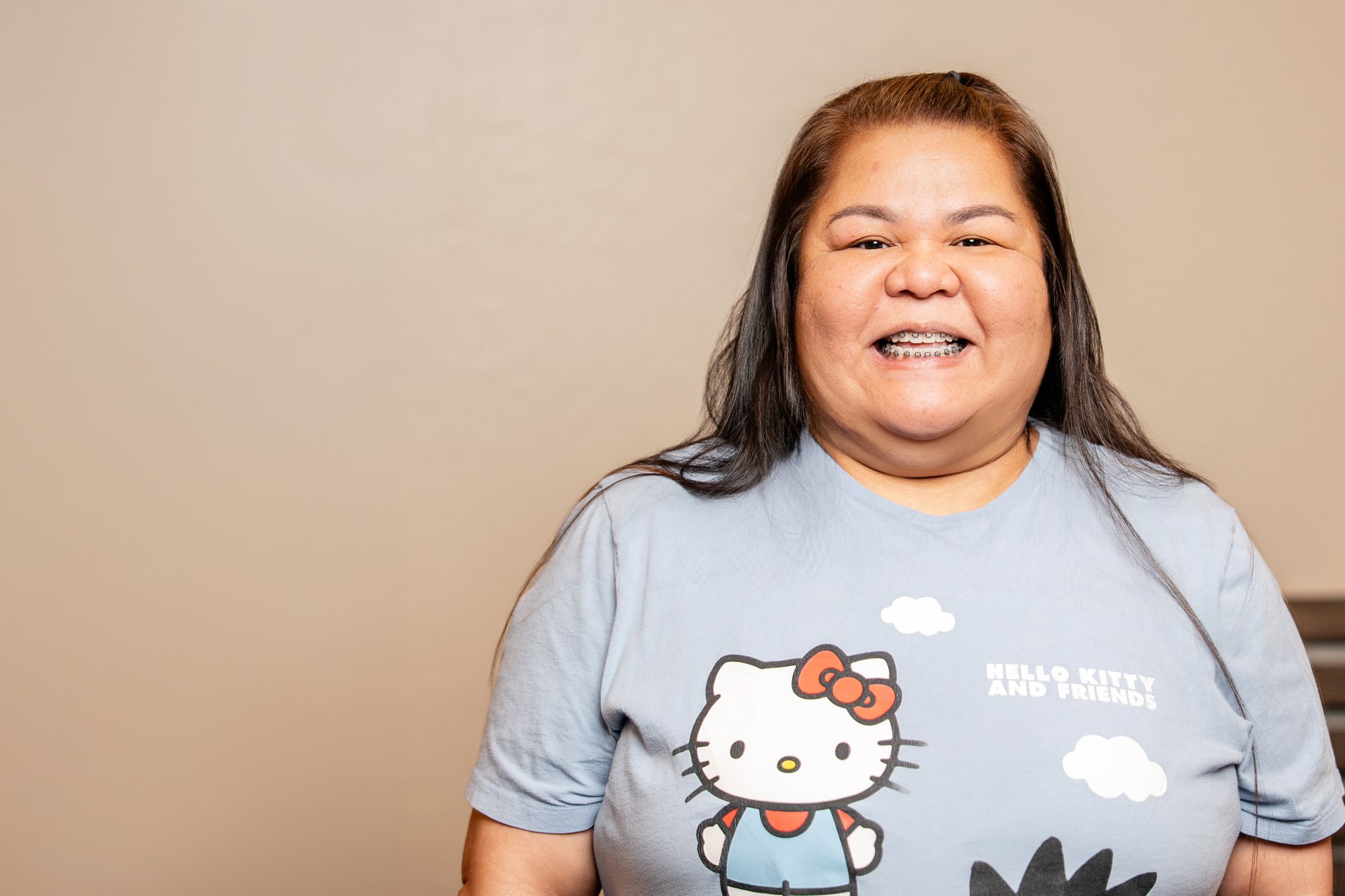 Maryann, a Premier Orthodontics patient, smiling with braces