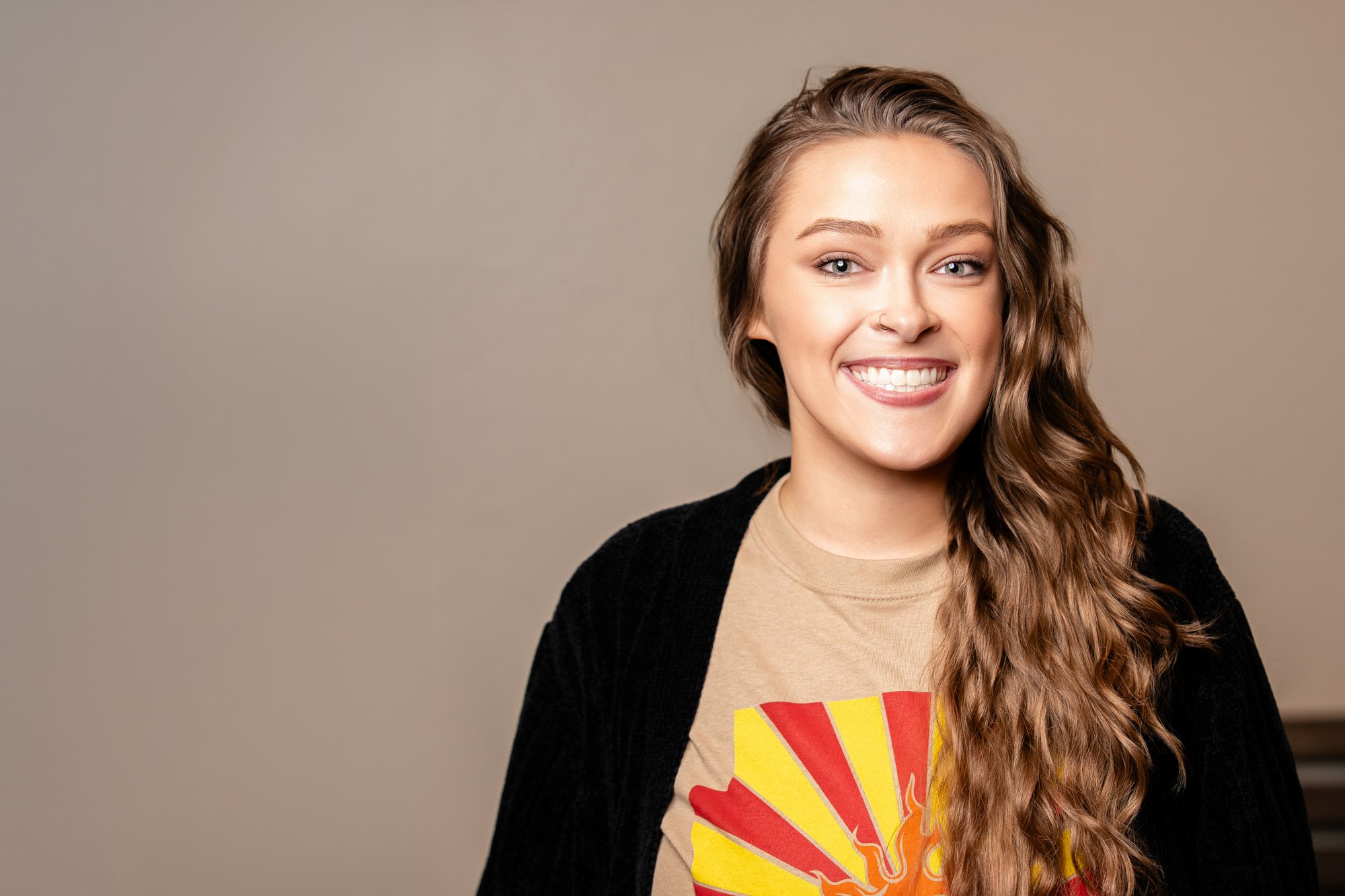 Amber Lynn, a Premier Orthodontics patient, smiling with braces
